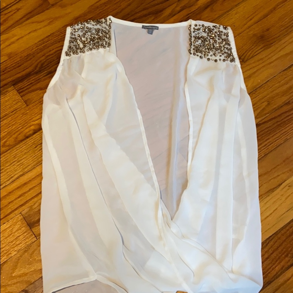 White shirt with sequin on the collar.